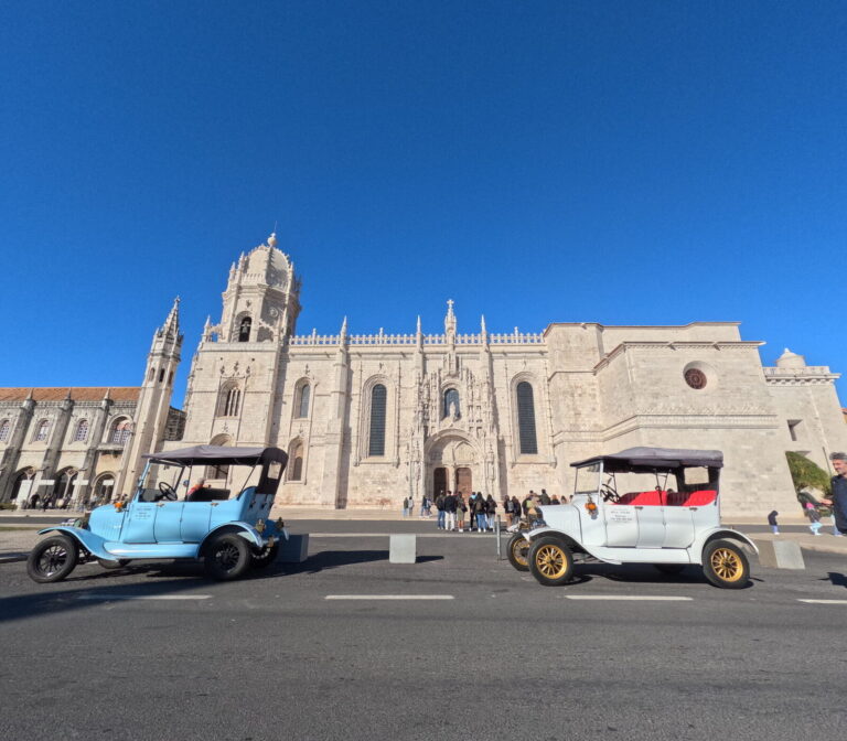 Two vintage tuktuks outside the Jerónimos Monastery